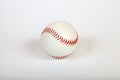 Close-up on a white baseball ball stitched with red thick thread made of genuine leather for the American team game on a white Royalty Free Stock Photo