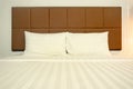 Close up white bed sheets and pillows in hotel or apartment. Front view of clean bedroom Royalty Free Stock Photo