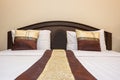 Close up white bed sheets and pillows in hotel or apartment. Front view of clean bedroom Royalty Free Stock Photo