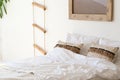 Close up white bedding sheets and pillow on wall room background. Bedroom with comfortable bed with soft white pillows. Royalty Free Stock Photo