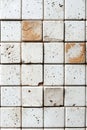 Close-up of a white and beige tile wall with a rustic texture Royalty Free Stock Photo