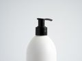 Close up white blank plastic bottle with black dispenser pump for gel, liquid soap, lotion, cream, shampoo on white Royalty Free Stock Photo