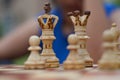 Close up of white chess pieces with focus on queen and king and pawn blurred out in background and foreground. Concept - idea,