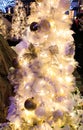 The close-up of a white Christmas tree with glowing lighting Royalty Free Stock Photo