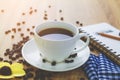 Close up white coffee cup on brown wood table near window