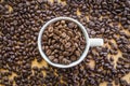 Close up of white coffee cup full of coffee beans background Royalty Free Stock Photo