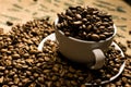 Close up of a white coffee cup full of coffee beans Royalty Free Stock Photo