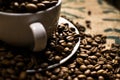 Close up of a white coffee cup full of coffee beans, surrounded Royalty Free Stock Photo