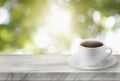 Close up white coffee cup on marble stage or table with nature background and glowing sparkles Royalty Free Stock Photo