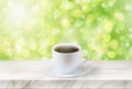 Close up white coffee cup on marble stage or table with nature background and glowing sparkles Royalty Free Stock Photo