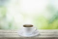 Close up white coffee cup on wood table with nature background and glowing sparkles Royalty Free Stock Photo