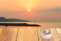 Close up white coffee cup on wood table and view of sunset or sunrise background Royalty Free Stock Photo