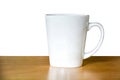 Close up of white coffee or tea cup on wooden table isolated on white background, copy space, clipping path Royalty Free Stock Photo