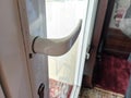 close up of white door handle on glass door Royalty Free Stock Photo