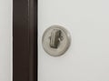 A close-up on a white door with round flush pull privacy kit, sliding pocket door bathroom lock