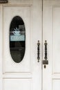 Close-up of white doors of an old restaurant with a sign - closed