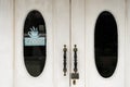 Close-up of white doors of an old restaurant with a sign - closed