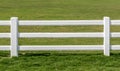 Close up white fences with green field background. Royalty Free Stock Photo