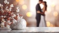 A close-up of white flowers on a table, with a couple sharing an intimate moment out of focus behind them. Can be used