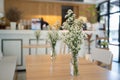 white flowers on wood table in the cafe
