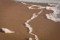 Close up white foam on the yellow sand, sea background Royalty Free Stock Photo