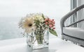 Beautiful white bouquet of flowers in vase on table of cruise ship.