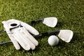 Close up of white glove, golf ball and golf clubs on grass with copy space Royalty Free Stock Photo