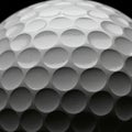 Close-up of a white golf ball highlighting its numerous dimples. The surface is glossy, Royalty Free Stock Photo