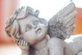 Sculpture of a white guardian angel lying on the wooden floor