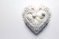 a close up of a white heart shaped object, intricate ornamental flourishes,