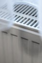 Close-up of a white heating radiator covered by soft fabric, showcasing the design and function. Ideal for home improvem Royalty Free Stock Photo