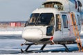 Close-up of a white helicopter with an open engine on the winter airport apron Royalty Free Stock Photo