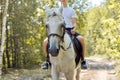 Close up of white horse running with teenage rider boy Royalty Free Stock Photo