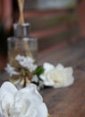 Close-up of white jazmin flowers on a rustic table. Aromatherapy set