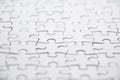Close up white jigsaw puzzle background. Royalty Free Stock Photo