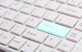 Close up of white keyboard with glowing blue enter button Royalty Free Stock Photo