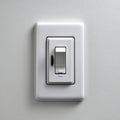 A close up of a white light switch on a neutral colored wall Royalty Free Stock Photo