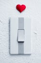 Close up of white light switch with a red heart Royalty Free Stock Photo