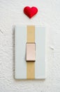 Close up of white light switch with a red heart Royalty Free Stock Photo