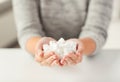 Close up of white lump sugar in woman hands