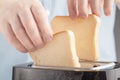 Close up of an white man making toasts at the kitchen