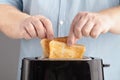 Close up of an white man making toasts at the kitchen