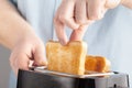 Close up of an white man making toasts at the kitchen