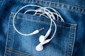 Close up white Mobile Headsets in jeans bag