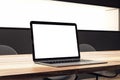 Close up of white mock up laptop display on wooden office desk. Workplace and technology concept. Royalty Free Stock Photo