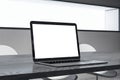 Close up of white mock up laptop screen on wooden office desk. Workplace and technology concept. Royalty Free Stock Photo