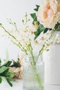 Close up of white orchid flowers in a glass vase with roses in b Royalty Free Stock Photo