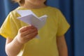 Close-up of a white origami paper bird in the hands of a child Royalty Free Stock Photo