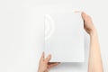 close-up of a white paper template in hands on a white background. Your book design layout.