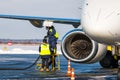 Close-up of a white passenger airplane refueling